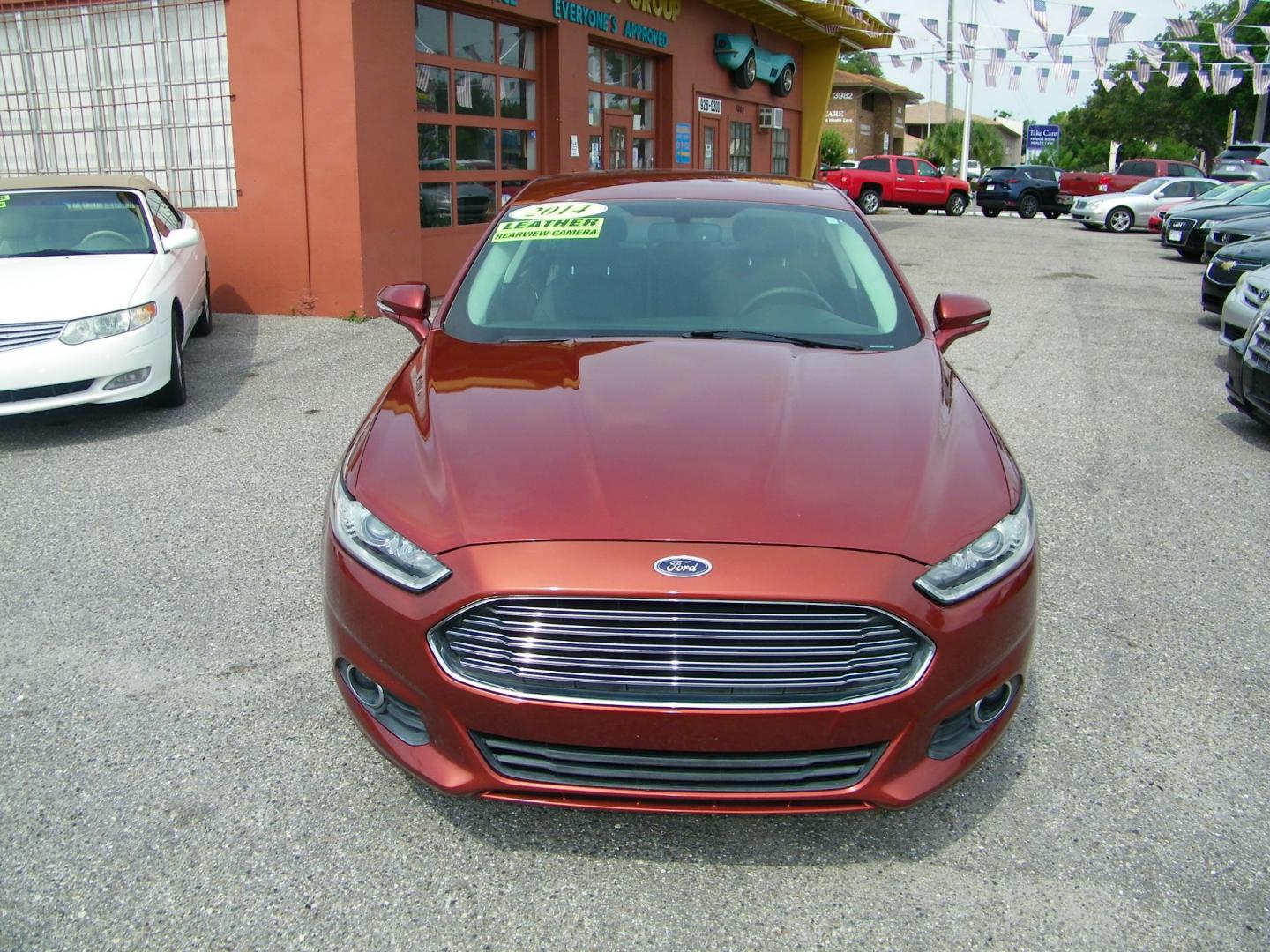 2014 Orange /Black Ford Fusion SE (3FA6P0HD7ER) with an 1.5L L4 DOHC 16V engine, Automatic transmission, located at 4000 Bee Ridge Road, Sarasota, FL, 34233, (941) 926-0300, 27.298664, -82.489151 - Photo#1